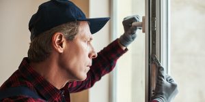 homeowner installing replacement windows